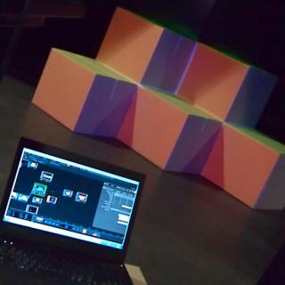 A projection mapping setup  for a set of cubes. Illustrates the combination of video art and sculpture. 